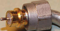Figure 7. The top image shows a 2,4 mm to 3,5 mm adaptor with the 2,4 mm end of the adaptor on the right. The male connector at the top is an SMA. The SMA male connector in the bottom image has a non-captive nut and a male conductor which is displaced axially (too long) and is slightly bent, perhaps from the bending of the semi-rigid cable adjacent to the connector